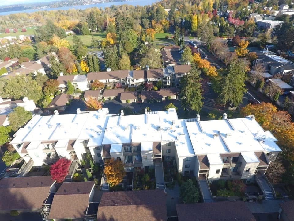 Drone aerial of a commercial TPO flat roof we installed in Seattle, lake beyond